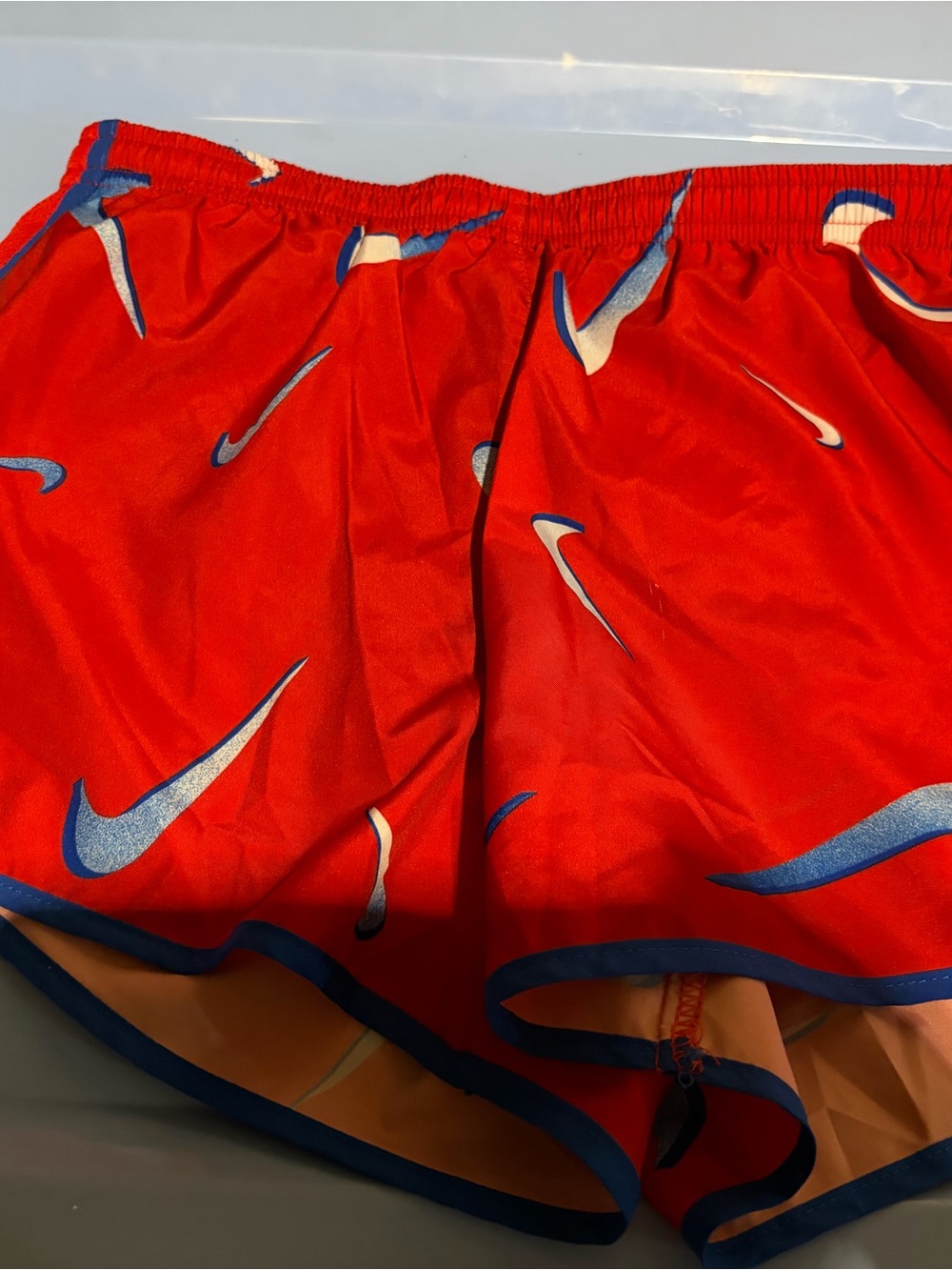 Nike Red Athletic Shorts with Blue Swoosh Accents